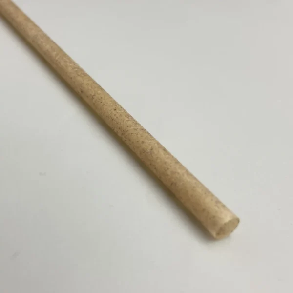 Close-up of an eco-friendly smoothie straw made from 100% recycled coffee grounds, featuring a natural brown texture and biodegradable material.